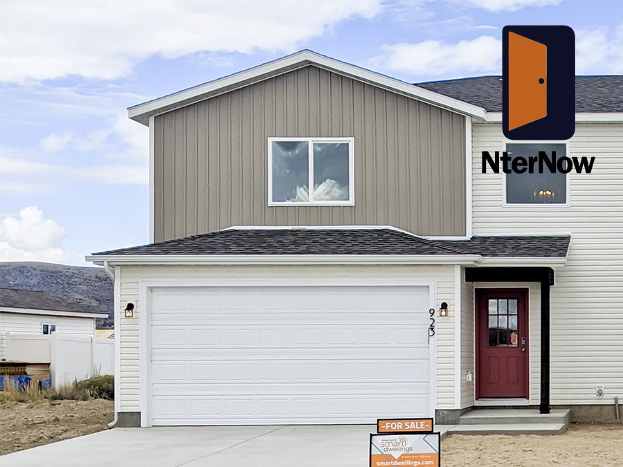 Front exterior view of new twin home with Rust Red front door, white 2-car garage and vaulted entryway - a new build by Smart Dwellings Front exterior view of new twin home with Rust Red front door, white 2-car garage and vaulted entryway - a new build by Smart Dwellings